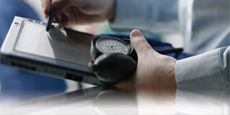 Close up image of a doctor using a computer tablet.